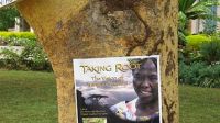 A Taking Root poster on a tree in Kenya advertising a campus screening. August 2010